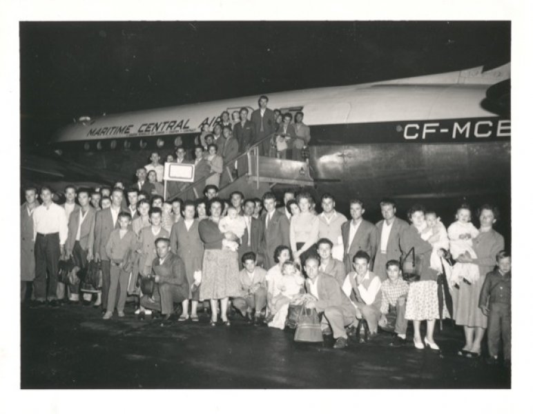 First Hungarian refugees with Immigration officer William A. McFaul at the former Montreal–Dorval airport, Montreal, Quebec,1956. Library and Archives Canada - PA-125700