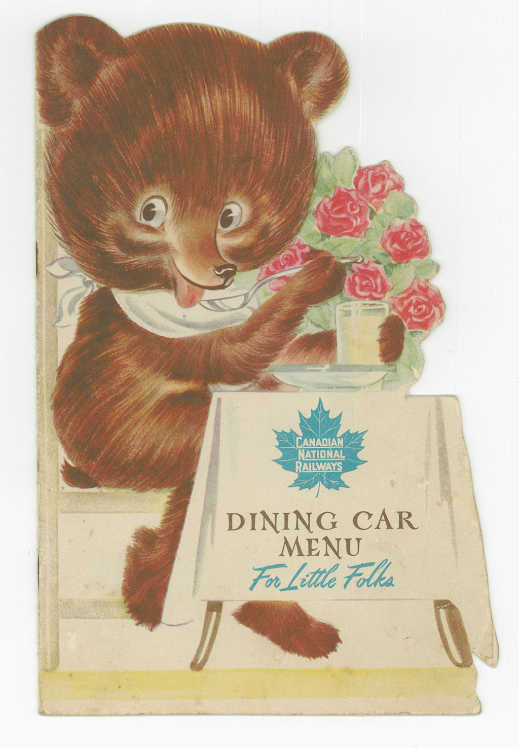 Recto d'un menu de train à l'ancienne. La page couverture montre un ours de bande dessinée portant une bavette et assis à une table.