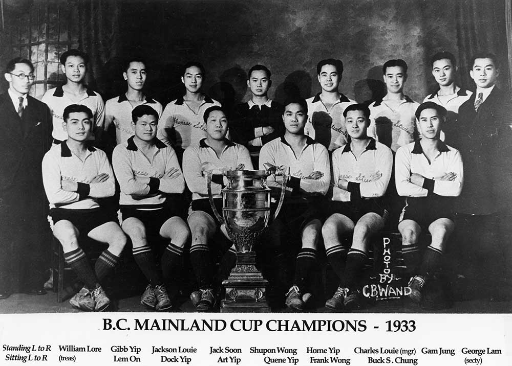 Quinze jeunes Canadiens d’origine chinoise disposés en deux rangées derrière un trophée. La plupart d’entre eux portent des maillots clairs portant l’inscription Chinese Students (Étudiants chinois).