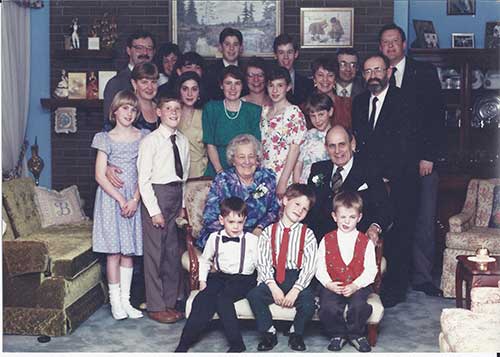 Trois générations de membres de la famille sont assis et debout pour une photo.
