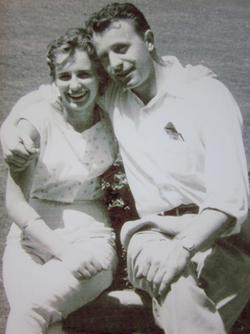 Un jeune homme et une jeune femme s’assoient sur le bras d’herbe.